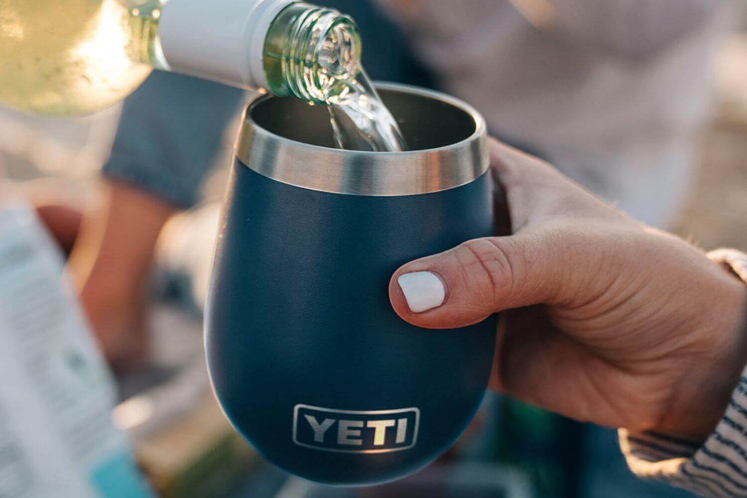 Elevate Your Brand With Custom Yeti Engraving Ideas featuring a YETI drinkware being filled.